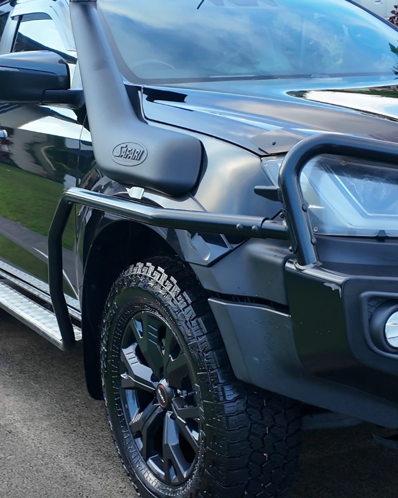 Black Isuzu D-MAX after a detail — snorkel, front guard and alloy wheel.